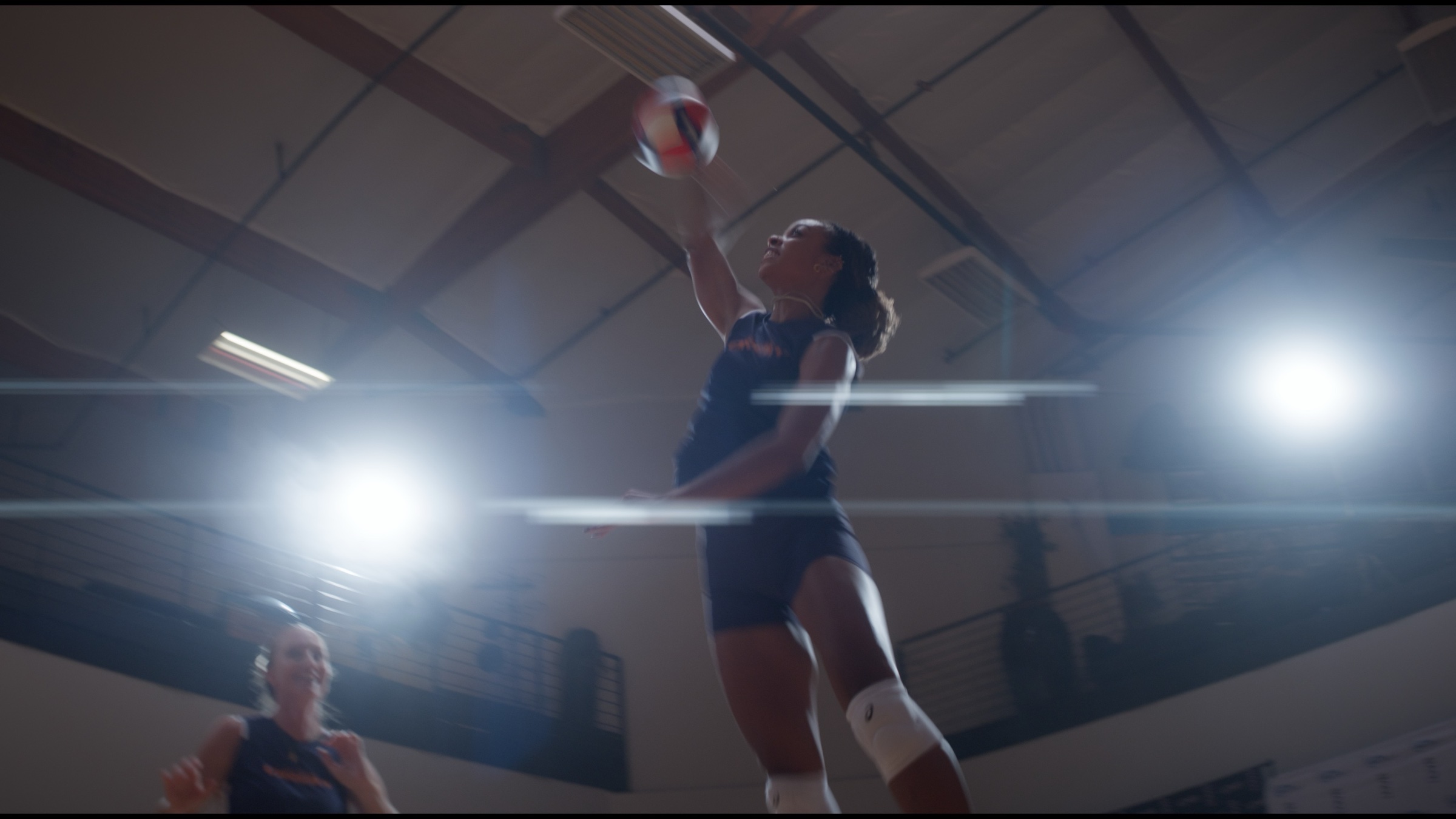 LA Orbit athlete jumping to strike a volleyball